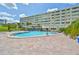 Community pool with surrounding patio and lounge chairs at 100 Bluff View Dr # 404A, Belleair Bluffs, FL 33770