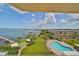 Aerial view of waterfront property with pool and lush landscaping at 100 Bluff View Dr # 404A, Belleair Bluffs, FL 33770
