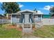 Newly renovated home with a charming front porch and well-maintained lawn at 8738 N Tangerine Pl, Tampa, FL 33617
