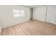 Bright bedroom featuring light wood-look flooring and neutral walls at 8738 N Tangerine Pl, Tampa, FL 33617