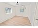 Bright bedroom with light wood-look flooring and neutral walls at 8738 N Tangerine Pl, Tampa, FL 33617
