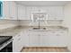 Modern kitchen with white shaker cabinets, granite countertops and stainless steel appliances at 8738 N Tangerine Pl, Tampa, FL 33617