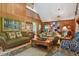 Spacious living room with wood paneling and large windows at 3520 Leslie West Rd, Dover, FL 33527