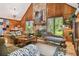 Spacious living room with a stone fireplace and wood paneling at 3520 Leslie West Rd, Dover, FL 33527