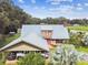 Aerial view of a house with metal roof, carport and landscaping at 3520 Leslie West Rd, Dover, FL 33527