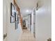 Clean basement hallway with tile flooring, laundry area, and stairway at 3520 Leslie West Rd, Dover, FL 33527