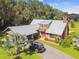 Aerial view of a house with metal roof, carport and landscaping at 3520 Leslie West Rd, Dover, FL 33527