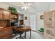 Home office with built-in desk and wood shelving at 3520 Leslie West Rd, Dover, FL 33527