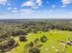 Aerial view of a vast property featuring a house, pastures, and outbuildings at 3520 Leslie West Rd, Dover, FL 33527
