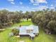 Aerial view of a house with metal roof and screened porch at 3520 Leslie West Rd, Dover, FL 33527