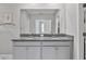 Bathroom with double vanity featuring gray cabinets and granite countertops at 10066 Corso Milano Dr, Tampa, FL 33625