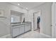 Bathroom features a double sink vanity, granite countertop, and a view into the walk-in closet at 10066 Corso Milano Dr, Tampa, FL 33625