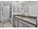 Elegant bathroom with double granite sinks and a bath/shower at 10066 Corso Milano Dr, Tampa, FL 33625