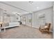 Spacious bedroom with neutral paint and carpet, ceiling fan, sitting area and many windows at 10066 Corso Milano Dr, Tampa, FL 33625