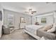 Spacious bedroom features two sitting chairs, multiple windows, and neutral paint at 10066 Corso Milano Dr, Tampa, FL 33625