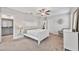 Bright bedroom featuring a ceiling fan, carpeted floors, white trim, and neutral paint at 10066 Corso Milano Dr, Tampa, FL 33625