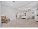 Large primary bedroom with carpeted floors, sitting area, neutral paint, and ceiling fan at 10066 Corso Milano Dr, Tampa, FL 33625