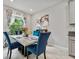 Elegant dining area with a marble-top table, comfortable seating, and natural lighting at 10066 Corso Milano Dr, Tampa, FL 33625
