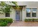 Inviting front entrance with a gray door, decorative wreath, and manicured landscaping at 10066 Corso Milano Dr, Tampa, FL 33625