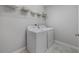 Laundry room with washer, dryer, wire racks, and neutral flooring at 10066 Corso Milano Dr, Tampa, FL 33625