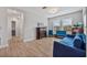 Bright living room features wood floors, a decorative fireplace, and large sofa in relaxing, natural light at 10066 Corso Milano Dr, Tampa, FL 33625