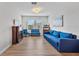 Bright living room features wood floors, a decorative fireplace, and large sofa in relaxing, natural light at 10066 Corso Milano Dr, Tampa, FL 33625