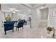 Open-concept living area with tile flooring, a ceiling fan, and plenty of natural light at 10066 Corso Milano Dr, Tampa, FL 33625