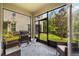 Enclosed patio with grill, outdoor seating, a patterned rug, and views of the backyard at 10066 Corso Milano Dr, Tampa, FL 33625