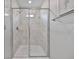 Shower features stylish gray tile, frameless glass door, shower head and faucet at 10066 Corso Milano Dr, Tampa, FL 33625