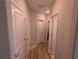 Bright hallway with hardwood floors and access to bedrooms at 10066 Corso Milano Dr, Tampa, FL 33625