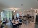 Open concept dining room, kitchen, and living area with a large island and table at 10066 Corso Milano Dr, Tampa, FL 33625