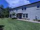 A gray two-story townhome with a front door and neatly landscaped lawn at 10066 Corso Milano Dr, Tampa, FL 33625