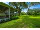 Spacious screened-in porch offering tranquil backyard views at 9328 Barak Ave, Seffner, FL 33584