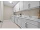 Laundry room with white cabinets and quartz countertop at 4281 Frontera Ln, Wesley Chapel, FL 33543