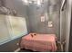 Charming bedroom with pink bedding and window at 4509 Tidal Pond Rd, New Port Richey, FL 34652