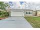 House exterior featuring a single-car garage and a well-maintained lawn at 4509 Tidal Pond Rd, New Port Richey, FL 34652