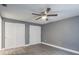 Spacious bedroom with double doors and ceiling fan at 4509 Tidal Pond Rd, New Port Richey, FL 34652