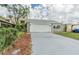 House exterior showcasing a single-car garage and landscaping at 4509 Tidal Pond Rd, New Port Richey, FL 34652