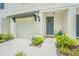 Townhouse with a modern gray door and well-maintained landscaping at 2714 Chestnut Creek Pl, Brandon, FL 33510