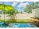 Private backyard with patio furniture and lush landscaping at 2714 Chestnut Creek Pl, Brandon, FL 33510
