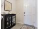 Modern entryway with black cabinet and white door at 2714 Chestnut Creek Pl, Brandon, FL 33510
