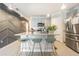 Contemporary kitchen with an island, geometric backsplash, and stylish barstools at 2714 Chestnut Creek Pl, Brandon, FL 33510