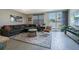 Spacious living room with comfy sectional sofa and large area rug at 2714 Chestnut Creek Pl, Brandon, FL 33510