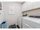 Laundry room with washer, dryer, and overhead cabinets at 2714 Chestnut Creek Pl, Brandon, FL 33510