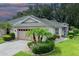 Charming one-story home boasts a manicured front yard, brick driveway, and an attached two-car garage at 604 Masterpiece Dr # 604, Sun City Center, FL 33573