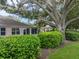 Mature trees and manicured hedges surround the backyard at 604 Masterpiece Dr # 604, Sun City Center, FL 33573