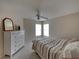 Guest bedroom with dresser and ceiling fan at 604 Masterpiece Dr # 604, Sun City Center, FL 33573