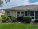 Spacious backyard with lush landscaping, screened patio, and grill at 604 Masterpiece Dr # 604, Sun City Center, FL 33573