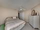 Spacious bedroom with a ceiling fan and dresser at 604 Masterpiece Dr # 604, Sun City Center, FL 33573