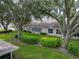 Large backyard with mature trees and lush greenery at 604 Masterpiece Dr # 604, Sun City Center, FL 33573